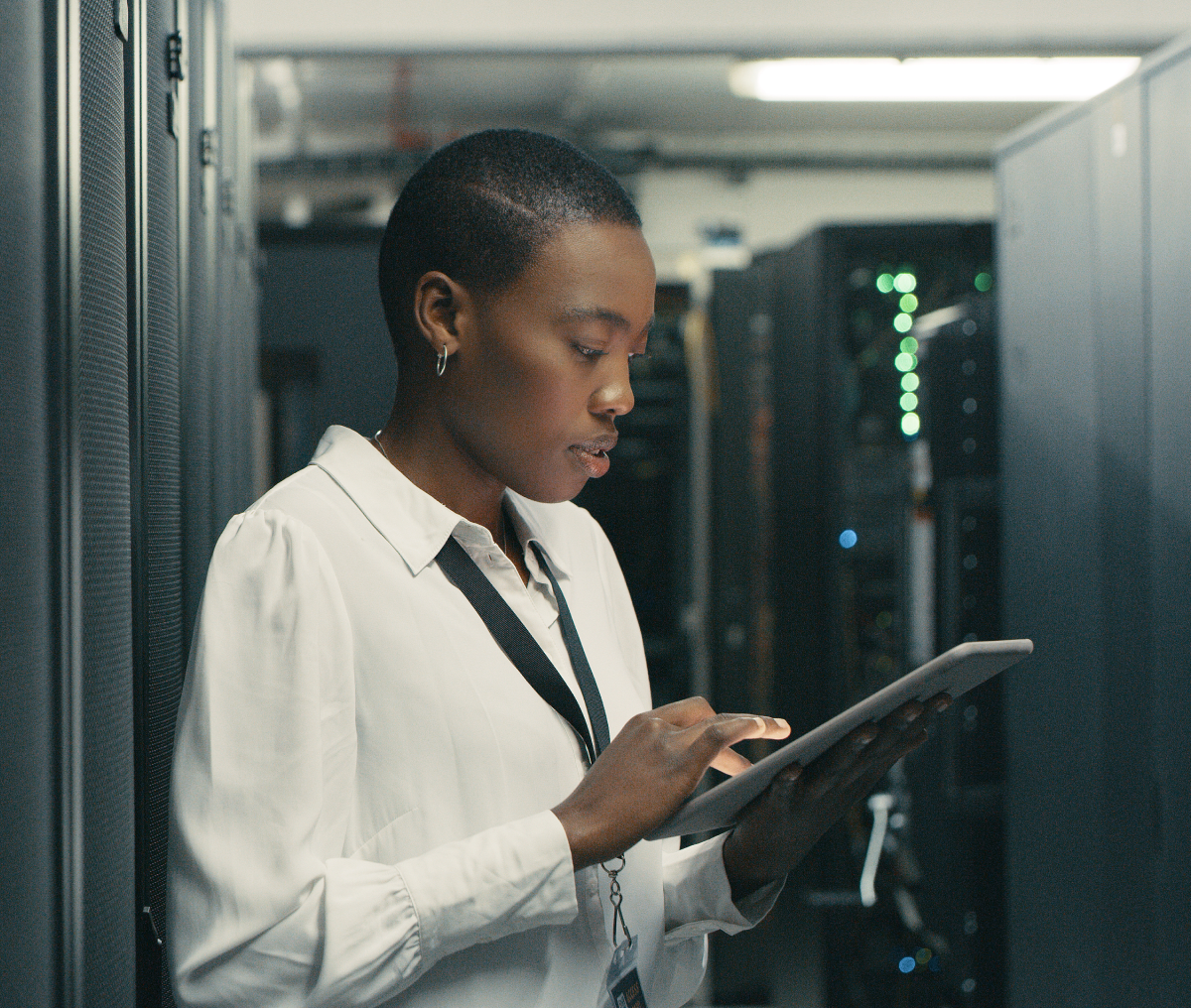 Woman using tablet in a server room