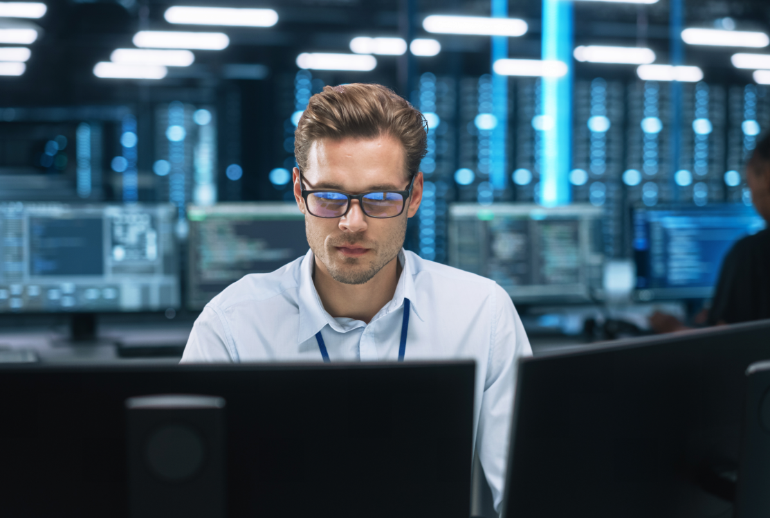 Man working at computer in server room